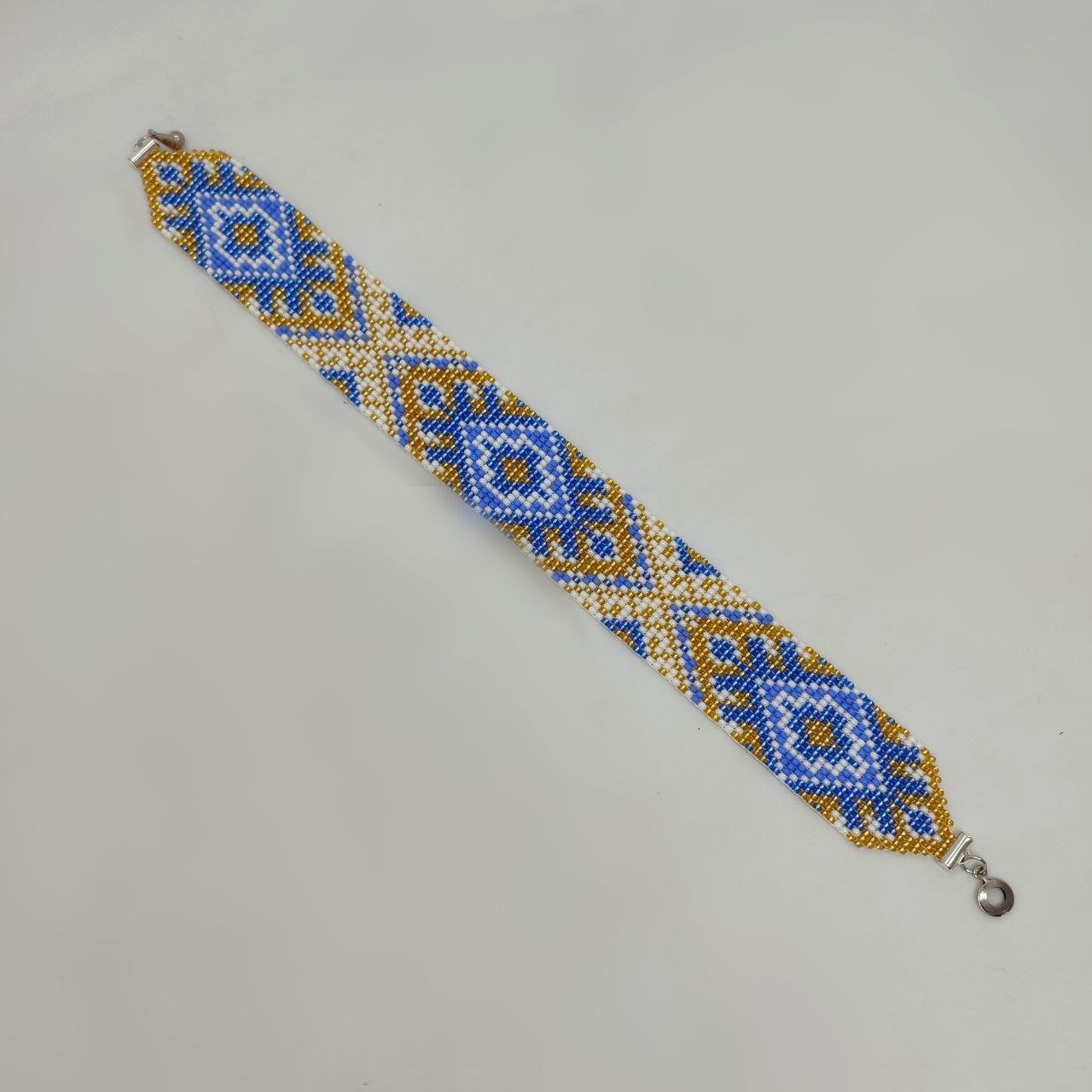 Блакитно-золотистий стрічковий гердан з орнаментом “Український”